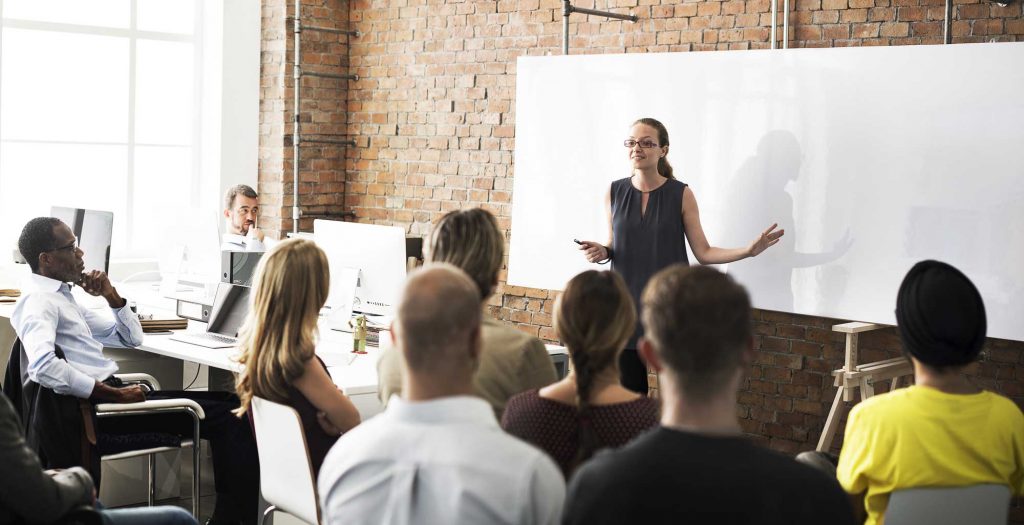 How To Be a Confident AND Humble Leader 7 speaking to a business meeting